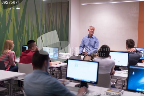 Image of teacher and students in computer lab classroom