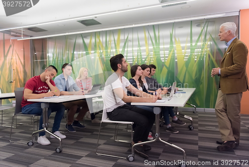 Image of teacher with a group of students in classroom