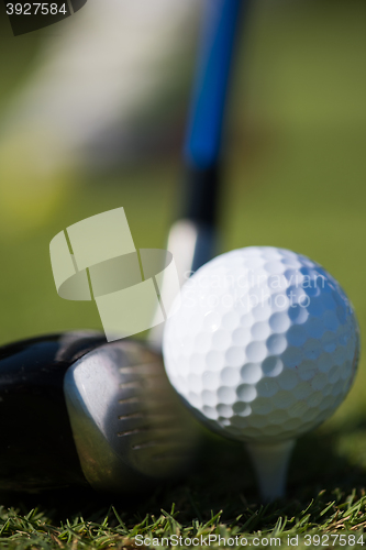 Image of golf club and ball in grass