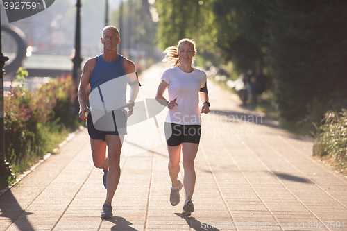 Image of couple warming up and stretching before jogging