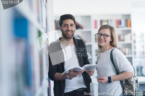 Image of students couple  in school  library