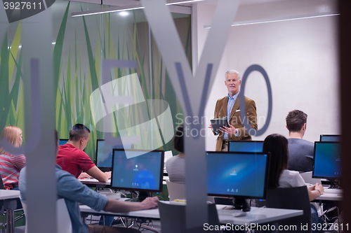 Image of teacher and students in computer lab classroom