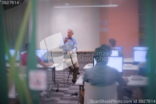 Image of teacher and students in computer lab classroom