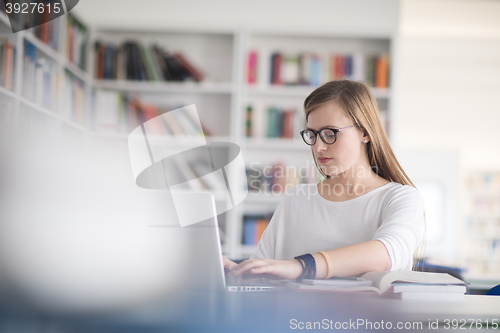 Image of female student study in school library