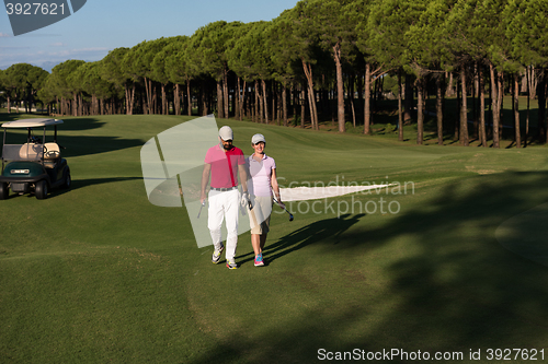 Image of couple walking on golf course