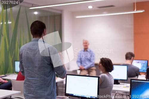 Image of student answering a question in classroom