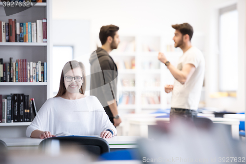 Image of female student study in school library, group of students in bac