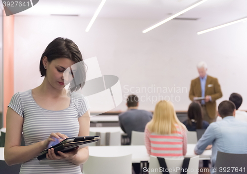 Image of portrait of happy female student in classroom