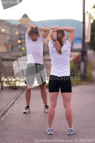 Image of couple warming up before jogging