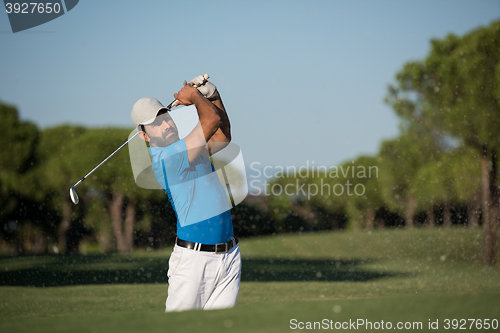 Image of pro golfer hitting a sand bunker shot