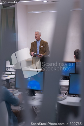 Image of teacher and students in computer lab classroom