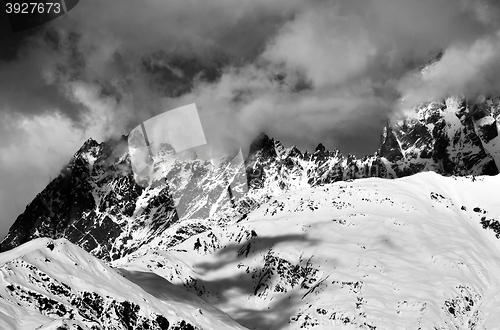 Image of Black and white snowy rocks in haze at sunny day