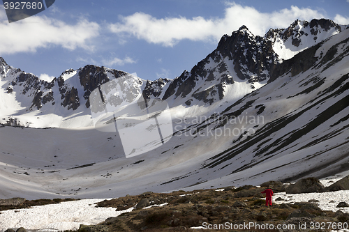 Image of Hiker in spring snowy mountains