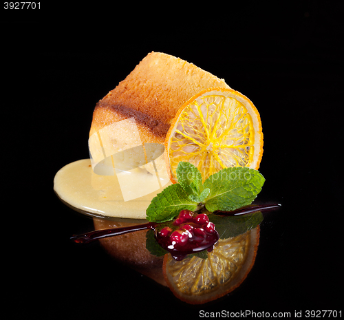 Image of fresh dessert decorated with orange and mint leaf