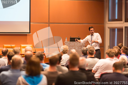 Image of Business speaker giving a talk in conference hall.