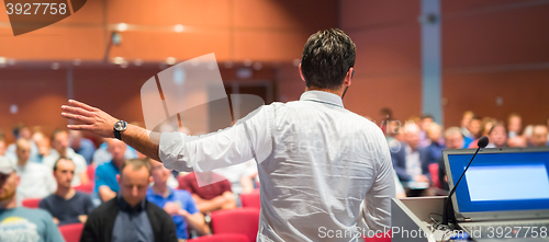 Image of Public speaker giving talk at Business Event.