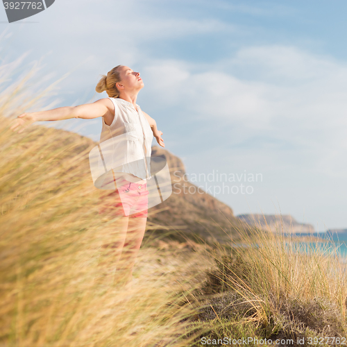 Image of Free Happy Woman Enjoying Sun on Vacations.