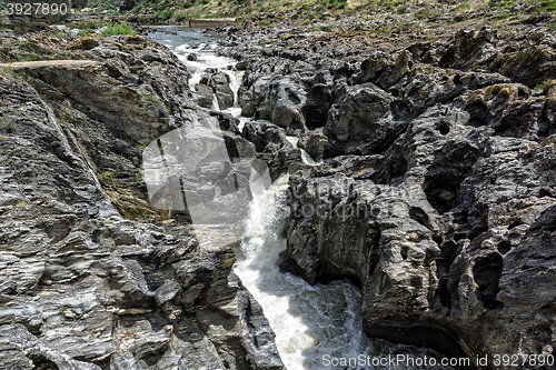 Image of Waterfall Flowing Between the Lava Stones