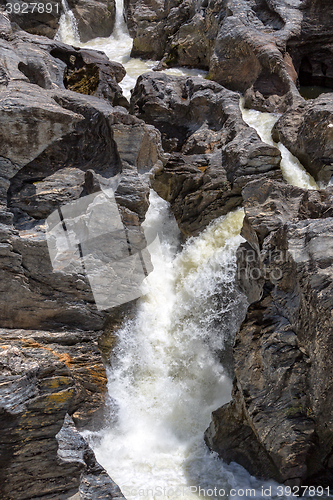 Image of Waterfall Flowing Between the Lava Stones