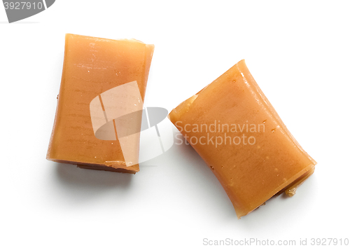 Image of caramel candies on white background