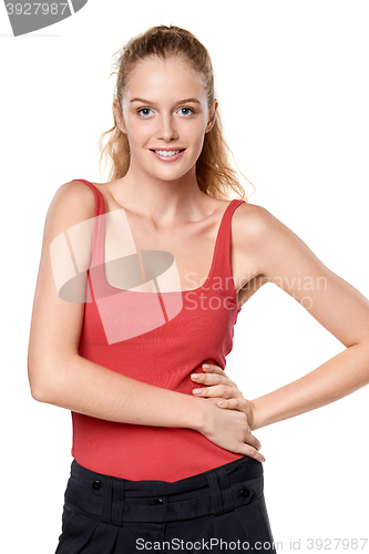 Image of Beautiful blond teen girl in red top standing casually