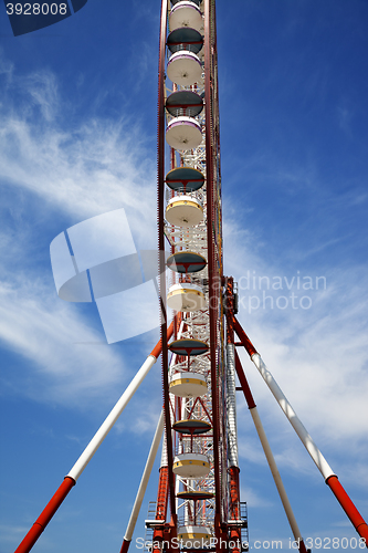 Image of Ferris wheel and blue sky with clouds