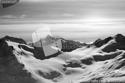 Image of Black and white snowy mountains in evening