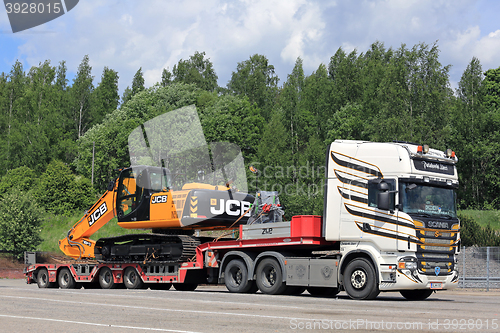 Image of Colorful Scania R560 and JCB Hydraulic Excavator on Trailer