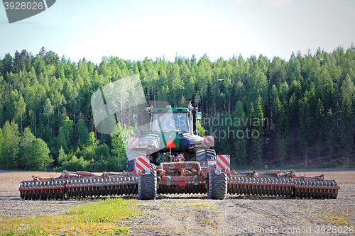 Image of John Deere Tracked Tractor and Cultivator on Field, Rear View 