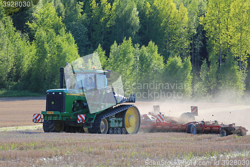 Image of John Deere 9520T Crawler Tractor and Cultivator on Spring Field
