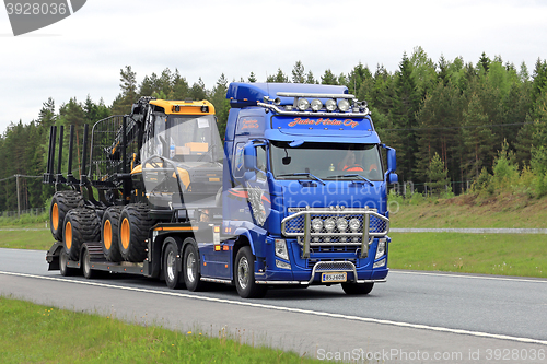 Image of Volvo FH Transports Ponsse Forwarder along Road