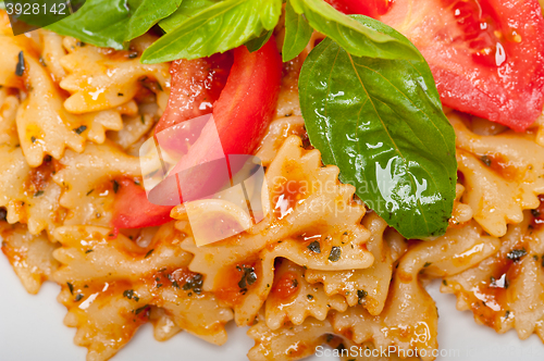 Image of Italian pasta farfalle butterfly bow-tie and tomato sauce