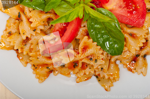 Image of Italian pasta farfalle butterfly bow-tie and tomato sauce