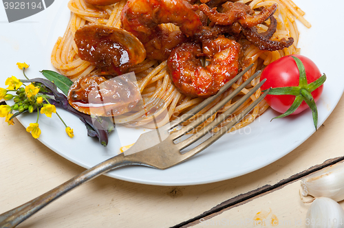 Image of Italian seafood spaghetti pasta on red tomato sauce 