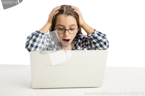 Image of Little girl working with a laptop