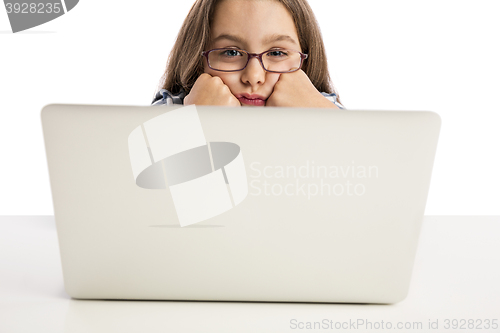 Image of Little girl working with a laptop