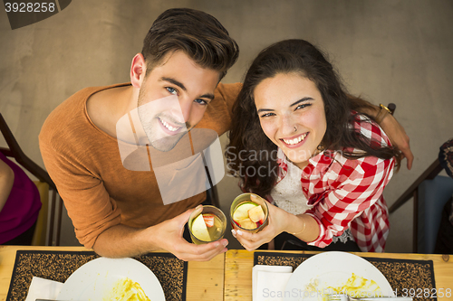 Image of Young couple toasting