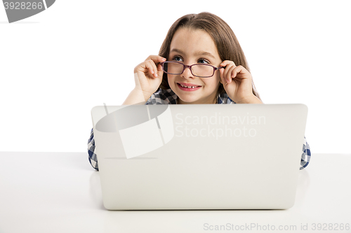 Image of Little girl working with a laptop