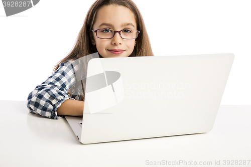 Image of Little girl working with a laptop