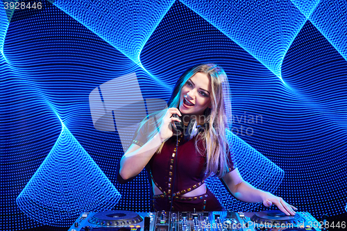 Image of DJ girl on decks at the party