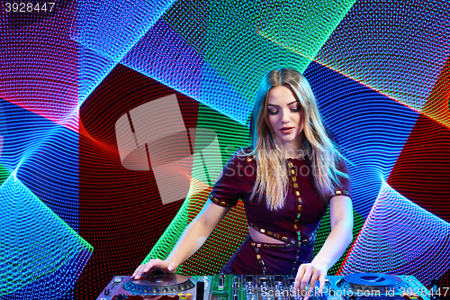 Image of DJ girl on decks at the party