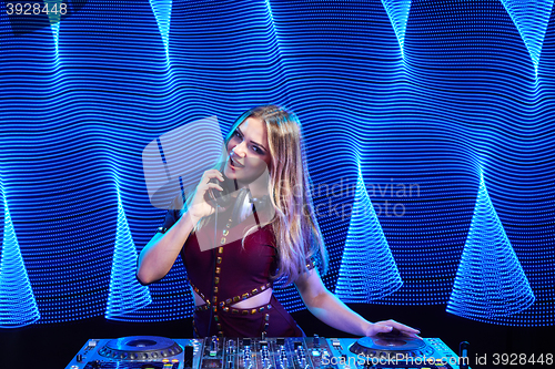 Image of DJ girl on decks at the party