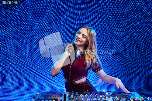 Image of DJ girl on decks at the party