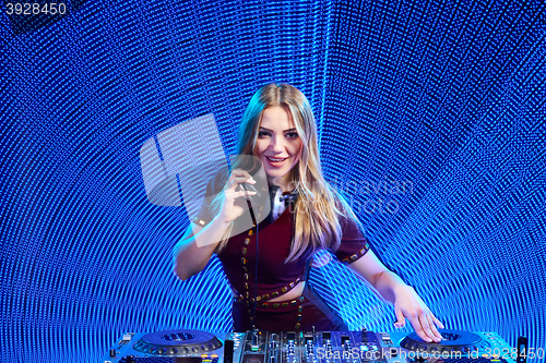 Image of DJ girl on decks at the party