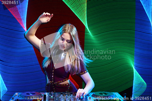 Image of DJ girl on decks at the party