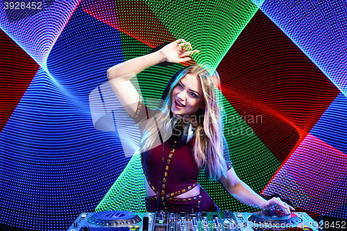 Image of DJ girl on decks at the party