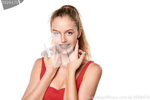 Image of Beauty portrait of young woman touching her face skin