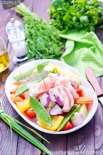 Image of raw meat with vegetables