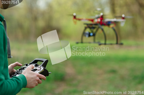 Image of Man controling a drone.