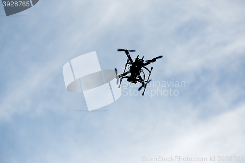 Image of flying drone with camera on the sky